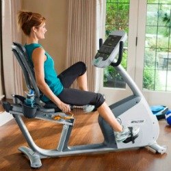 Precor Exercise Bike - Woman Exercising In Home Gym